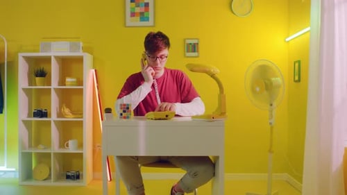 Man Is Talking On Telephone In Home Office