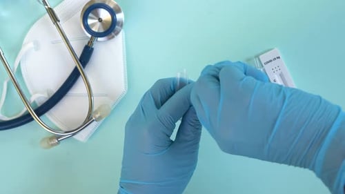 Hands in Gloves Preparing Medical Test