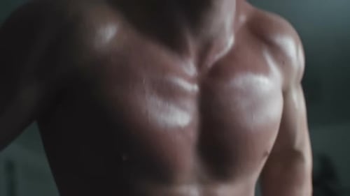 Muscular Man Doing Dips in Gym Close Up
