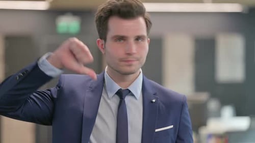 Portrait of Businessman Showing Thumbs Down Gesture