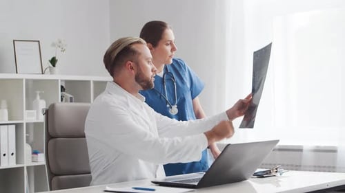 Professional medical doctors working in hospital office. Physician and the young nurse.
