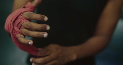 African Athlete is Wrapping Hand Before Fight or Training in Fight Club Closeup View Prores