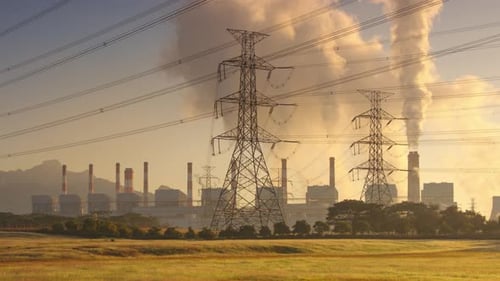 Power Plant with Electrical Towers at Sunset