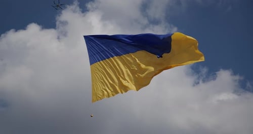 Ukrainian Flag Waving Proudly Against Cloudy Sky