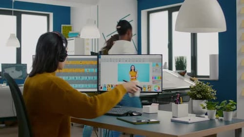 Woman Designs Graphics at Desk in Modern Office