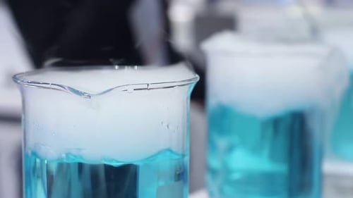 Blue Liquid Bubbling in Laboratory Glassware