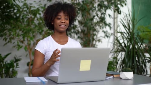 Woman Talking on Video Call at Desk