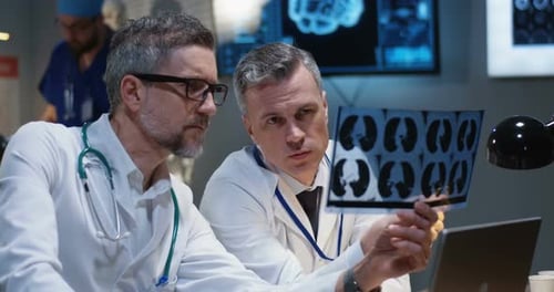 Doctors Examine X-Ray in Hospital Office