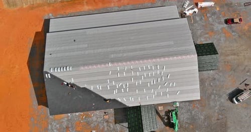 A Asphalt Shingles Installation on the Roof Roofer is Nailing Asphalt Shingles to Roofing