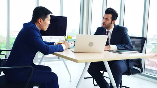 Two Business People Talk Project Strategy at Office