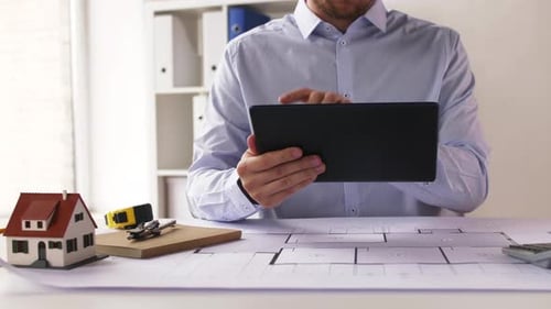 Architect Working on Tablet at Office Desk
