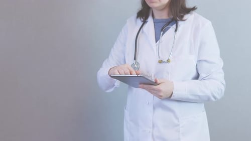 Female Doctor Using Tablet in Medical Setting