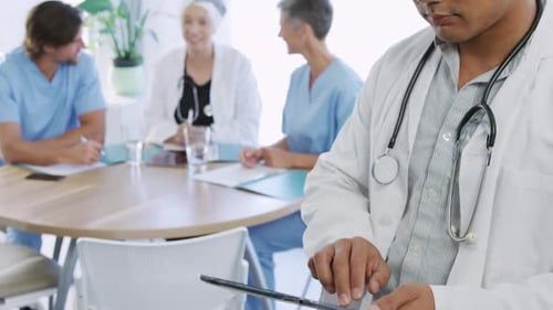 Asian Doctor Smiling in Medical Clinic Meeting