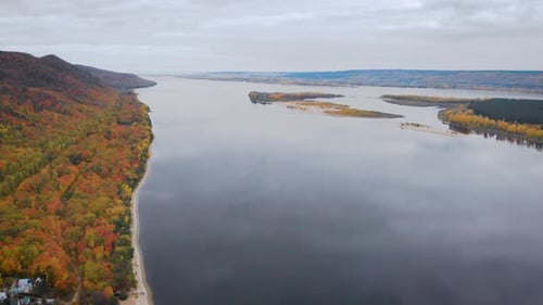 Aerial View. Autumn, a Large River Among the Forest Hills. The Trees Are Already in Yellow and