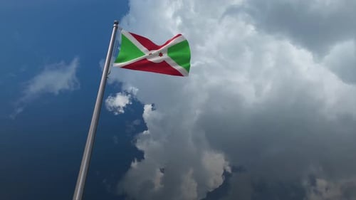 Realistic Burundi National Flag Waving on Pole Against Cloudscape