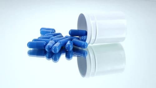 Medicine Blue Pills in a Bottle, on White, Rotation, Reflection