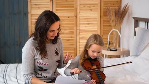 Girl Learning Violin with Teacher at Home