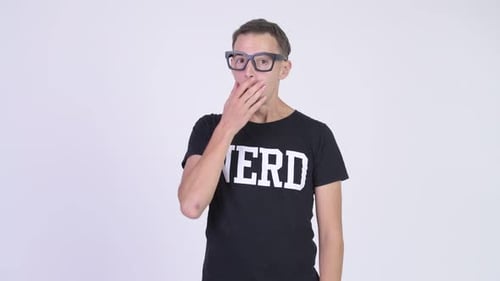 Studio Shot of Nerd Man Covering Mouth and Looking Guilty
