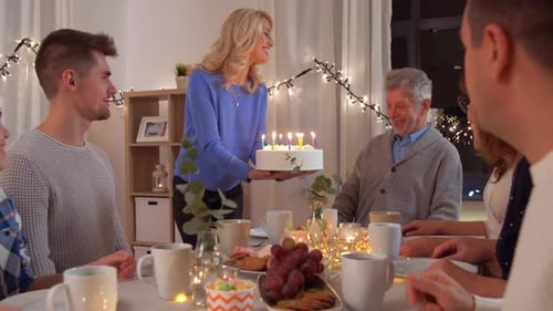 Family Celebrates Birthday With Cake and Candles