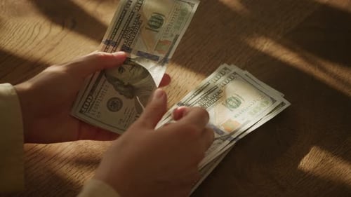 Handheld Close Up of Caucasian Woman Hands Counting Money in Slow Motion