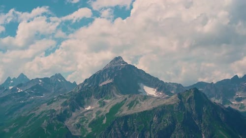 Mountain Peaks Against Cloudy Sky. Peaks of Magnificent Rocks Located Against Bright Cloudy Sky on