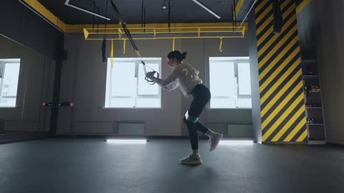 Crossfit Fitness TRX Training Exercises at Gym Woman Pushup Workout