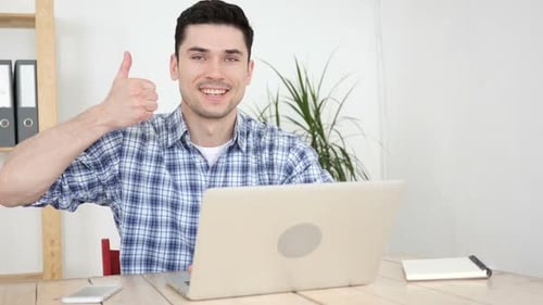 Thumbs Up By Man Working in Office