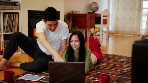 Couple Relaxing at Home With Laptop