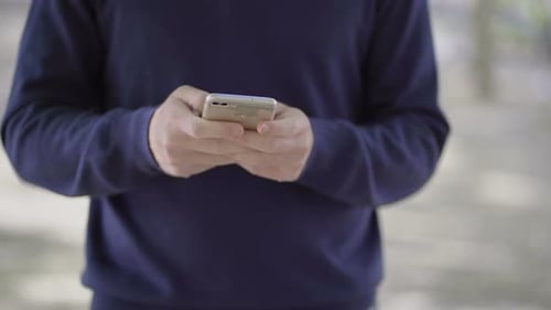 Person Using Cell Phone in Urban Setting