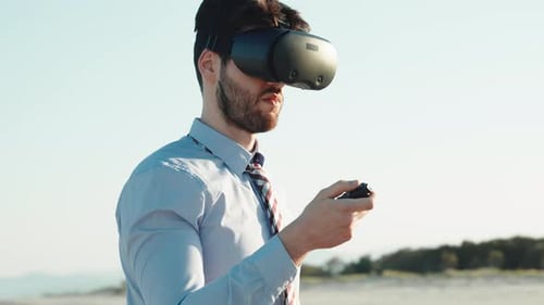 Man Using Virtual Reality Headset at Beach