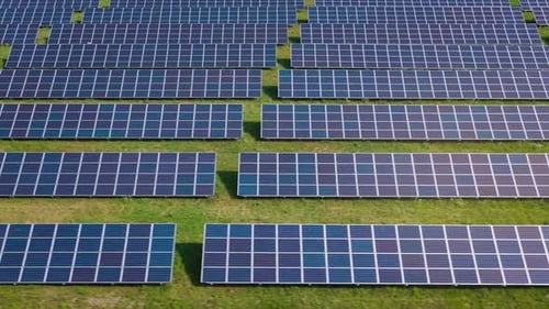 Flight Over a Field of Solar Panels in Sunny Summer Day