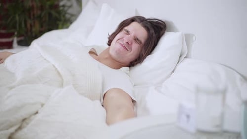 Young Adult Man Waking Up and Stretching