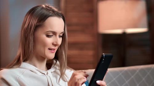 Woman Uses Smartphone in Interior Close-Up