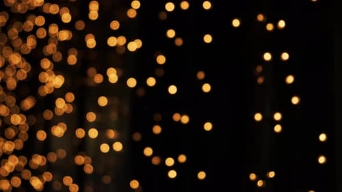 Abstract Golden Shimmering Bokeh Lights on Black