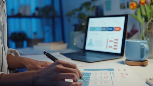 asia business lady freelance focus on laptop write worksheet finance graph account chart market plan