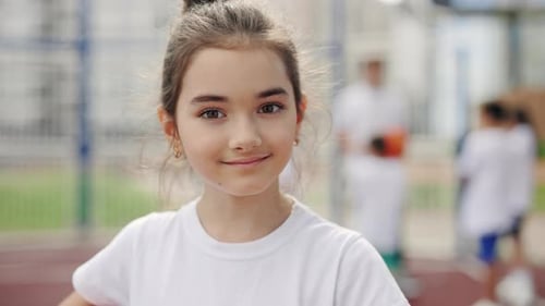 Young Girl Smiling at Basketball Court