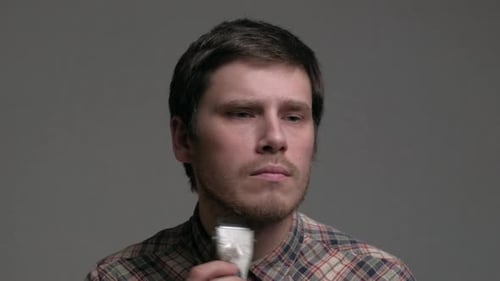 Man Trims His Beard with Electric Trimmer