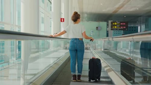 Young Millennial Traveler Woman in Empty Airport