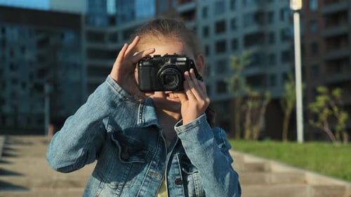 Girl Having Fun Taking Pictures with Camera
