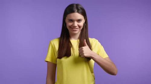 Smiling Young Adult Woman Giving Thumbs Up