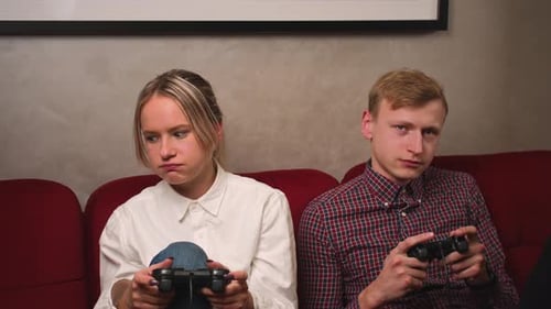 Man and Woman Play Video Game on Couch