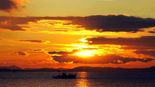 Sunset Silhouette: Boat on the Ocean at Dusk