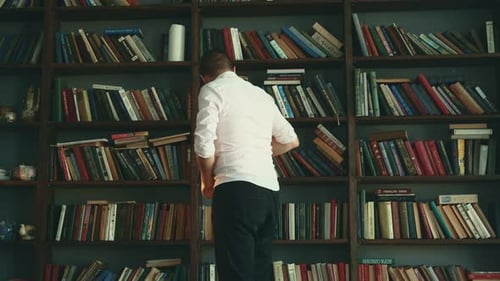Man on Background of Bookshelves