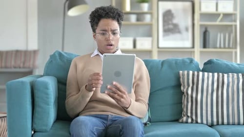Woman Uses Tablet on Couch in Living Room