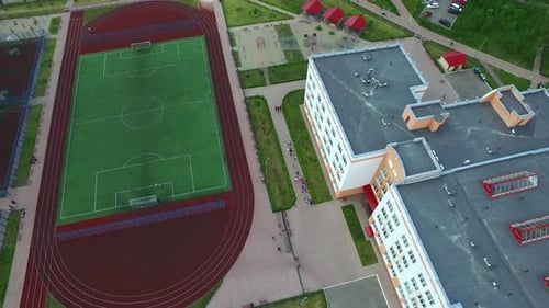 Football Field and Stadium in School Yard. Aerial View Sport Ground in Courtyard