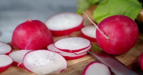 Fresh Red Radishes on Cutting Board Close Up