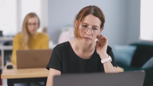 Woman Working on Laptop at Office
