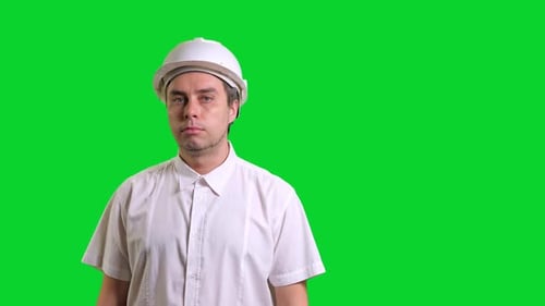 Young Male Engineer Standing and Smiling on Green Screen Background