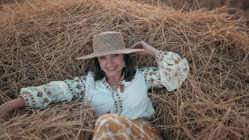 Woman Relaxing in Hay Field Smiling