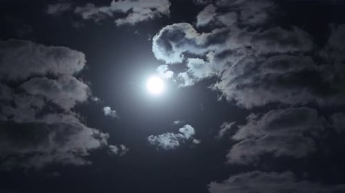 Moon and Clouds Drifting across the Night Sky